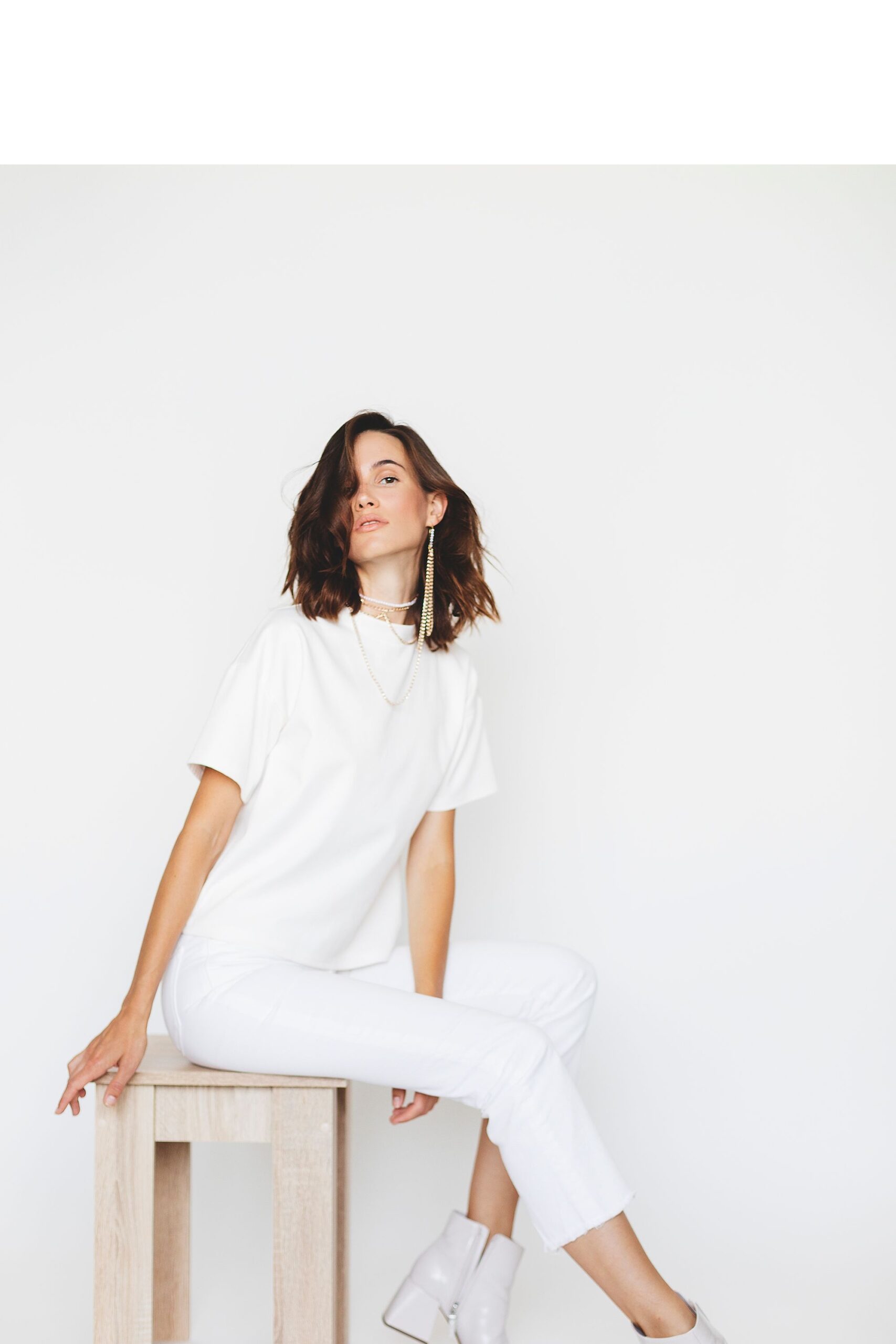 Woman wearing white showing her results from moxi laser treatment