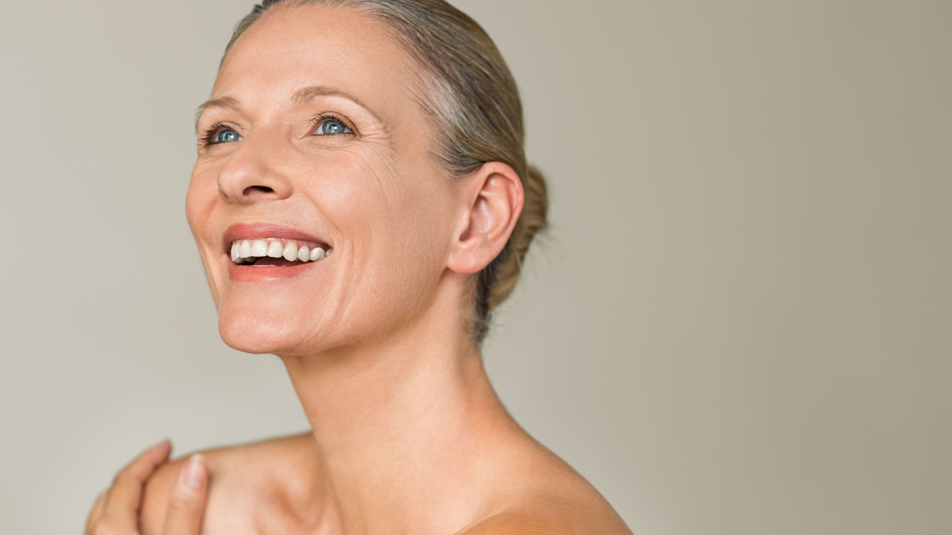 elderly white women smiling to the left of the camera