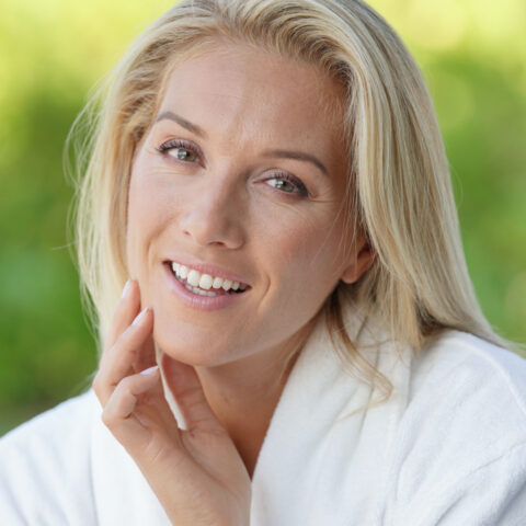 middle aged woman with blond hair looking into the camera