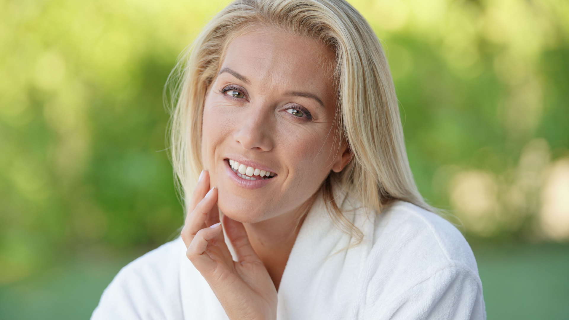 middle aged woman with blond hair looking into the camera