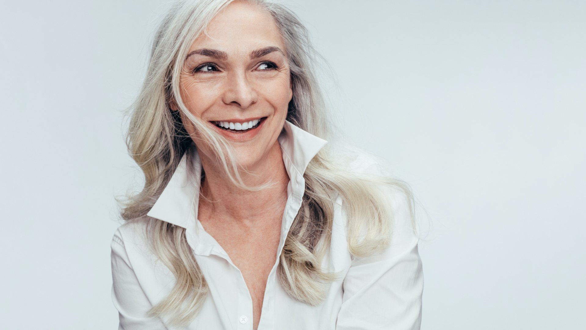 woman with white hair looking at the camera