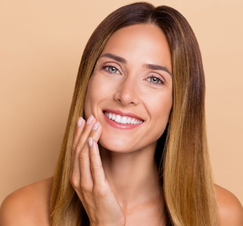 woman smiling after getting skin tighten