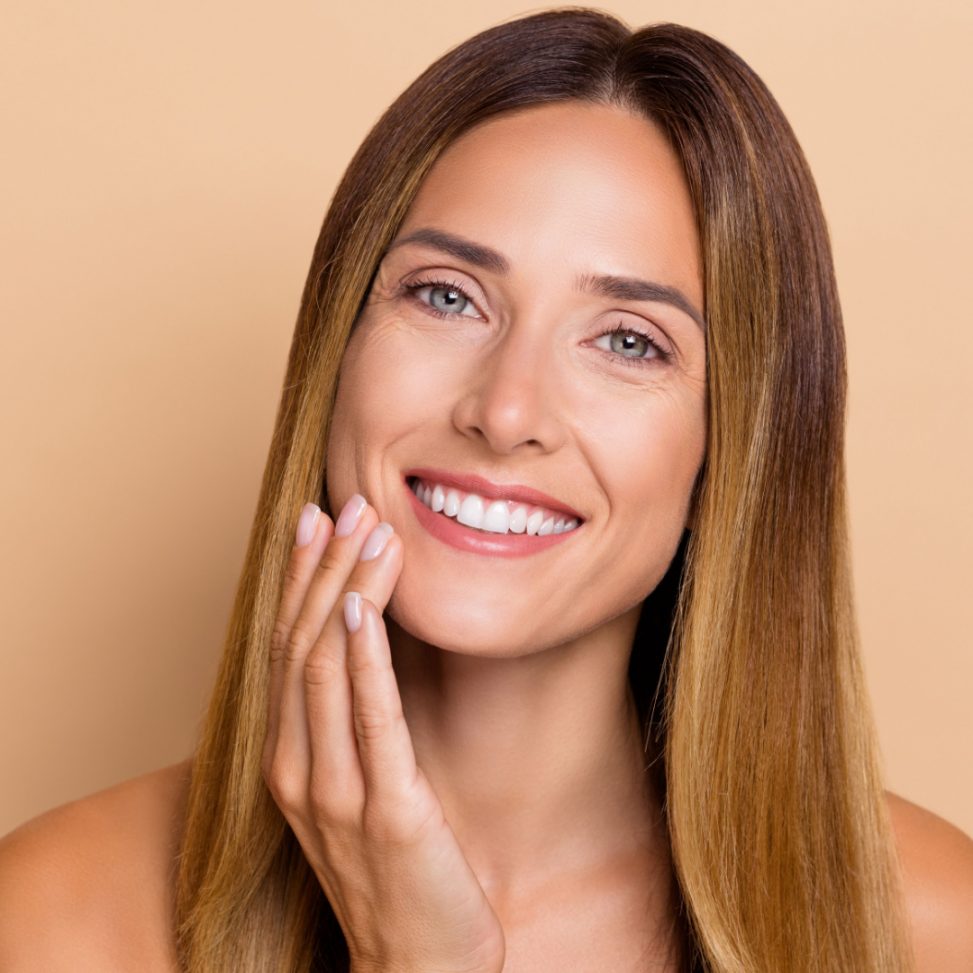 woman smiling after getting skin tighten