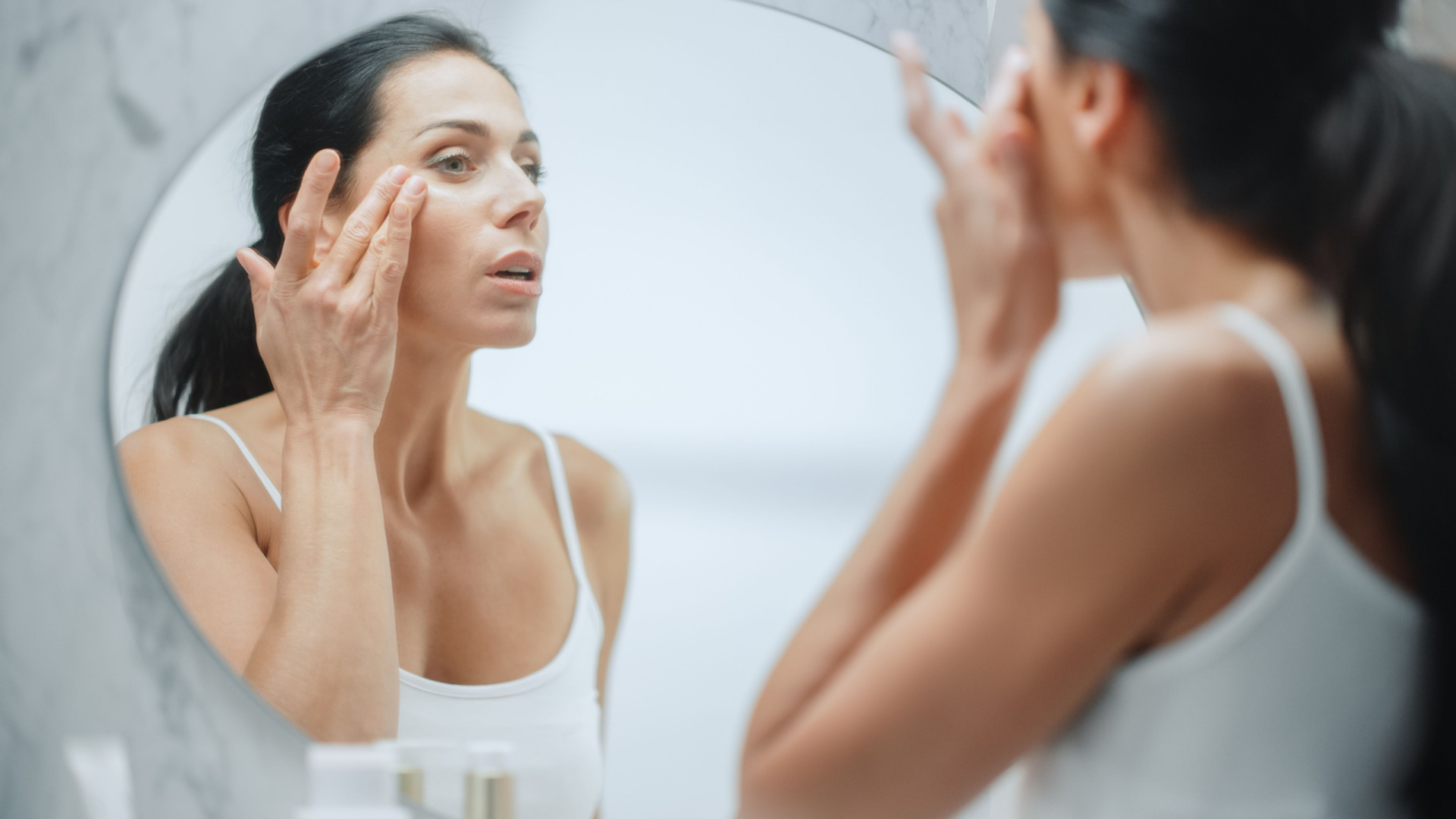 woman looking into the mirror