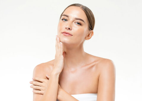 women touching her face and looking at the camera
