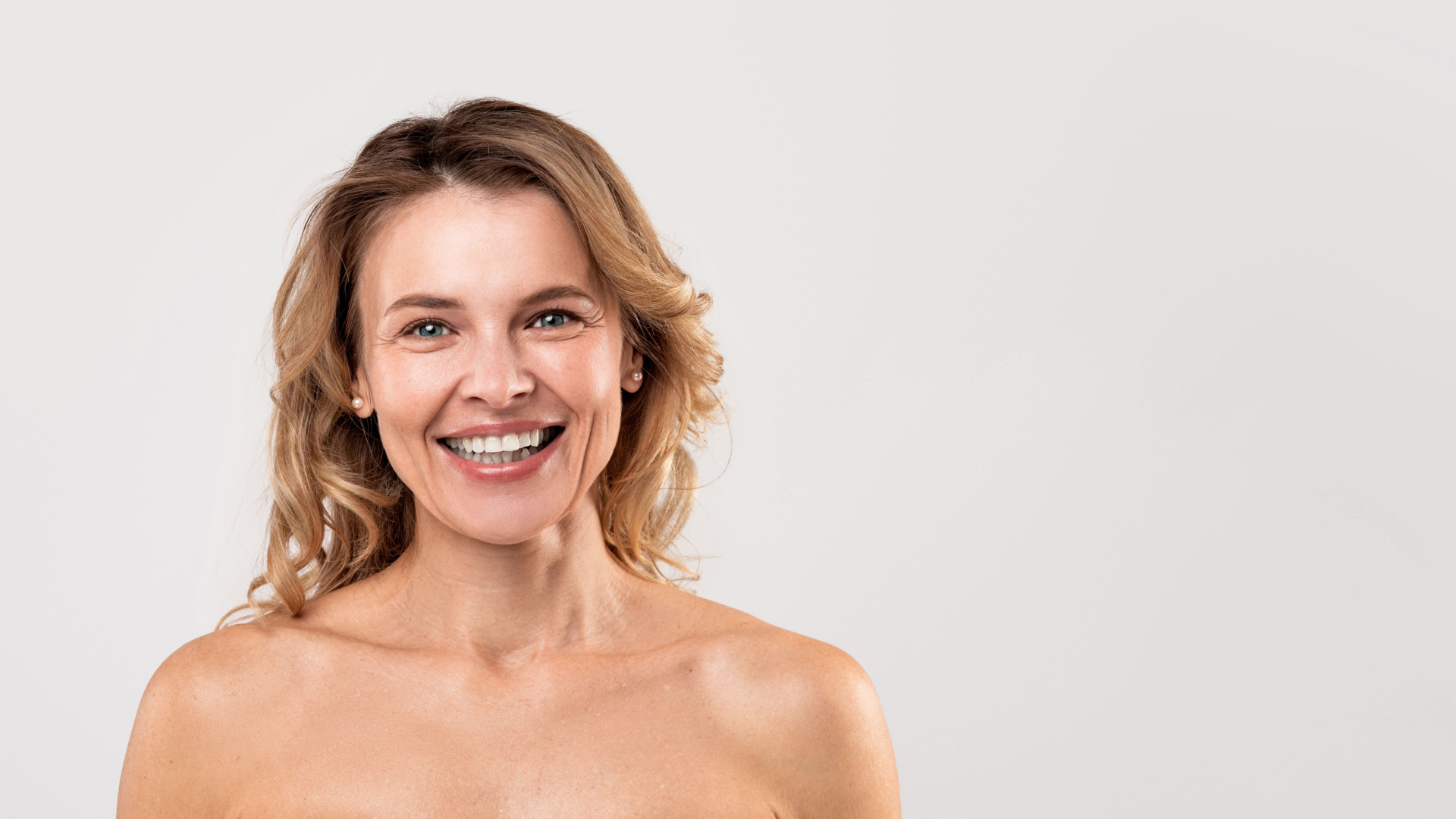 elderly white women smiling at the camera with a white background