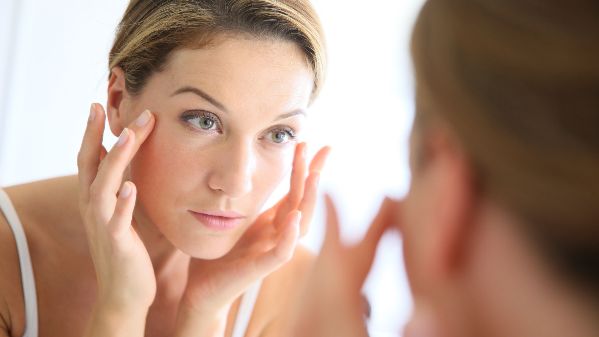 woman looking into a mirror