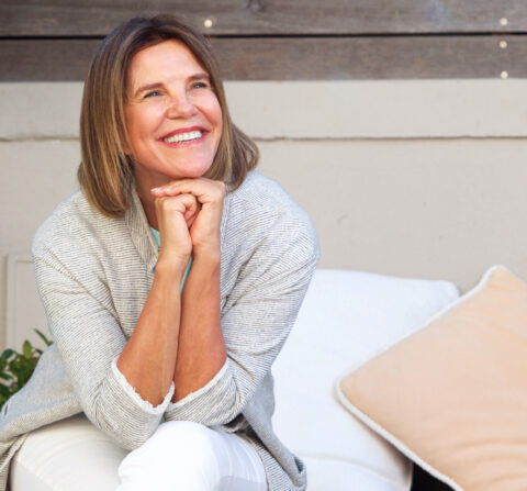 older white women smiling away from the camera with outside background