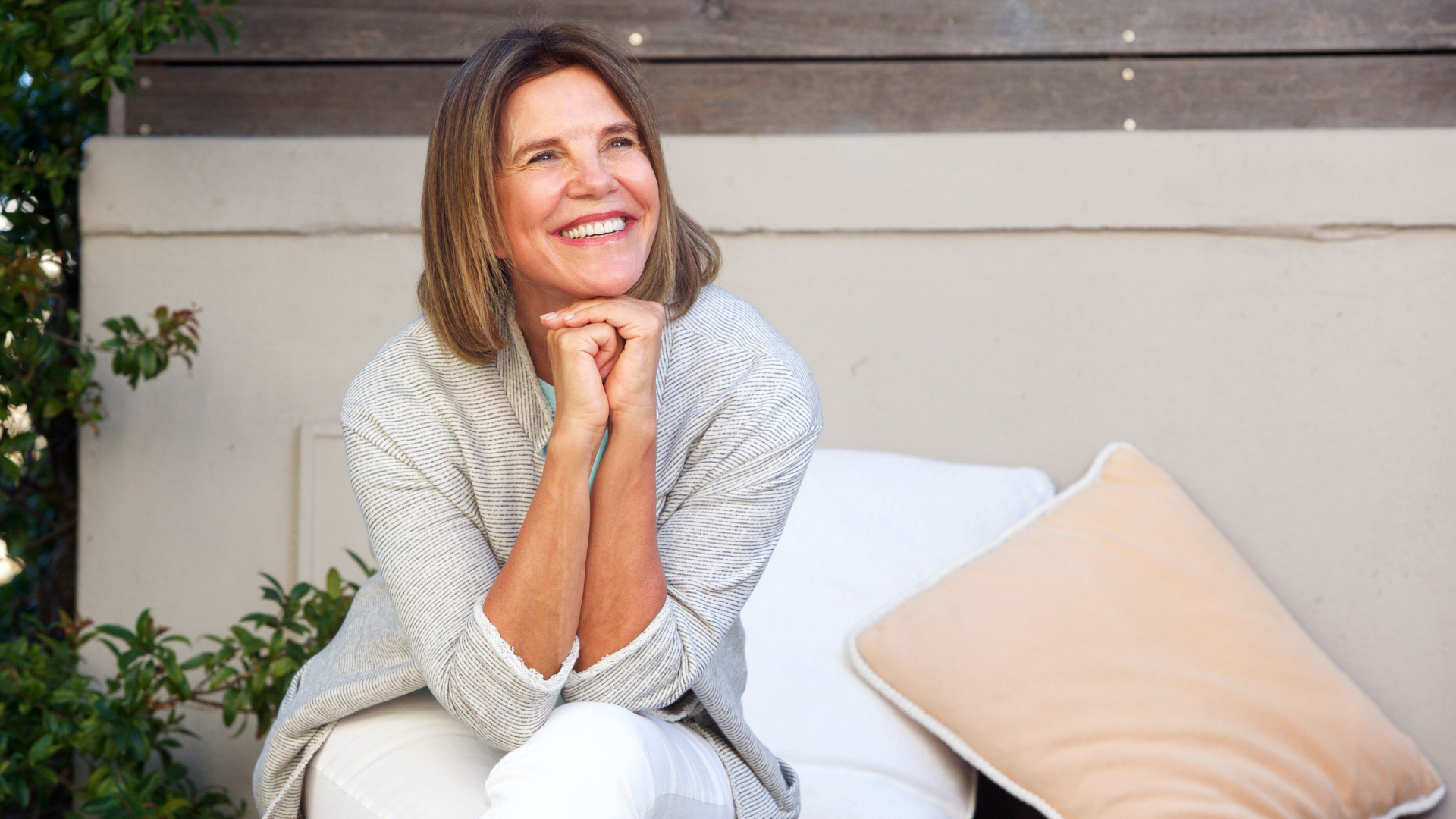 older white women smiling away from the camera with outside background