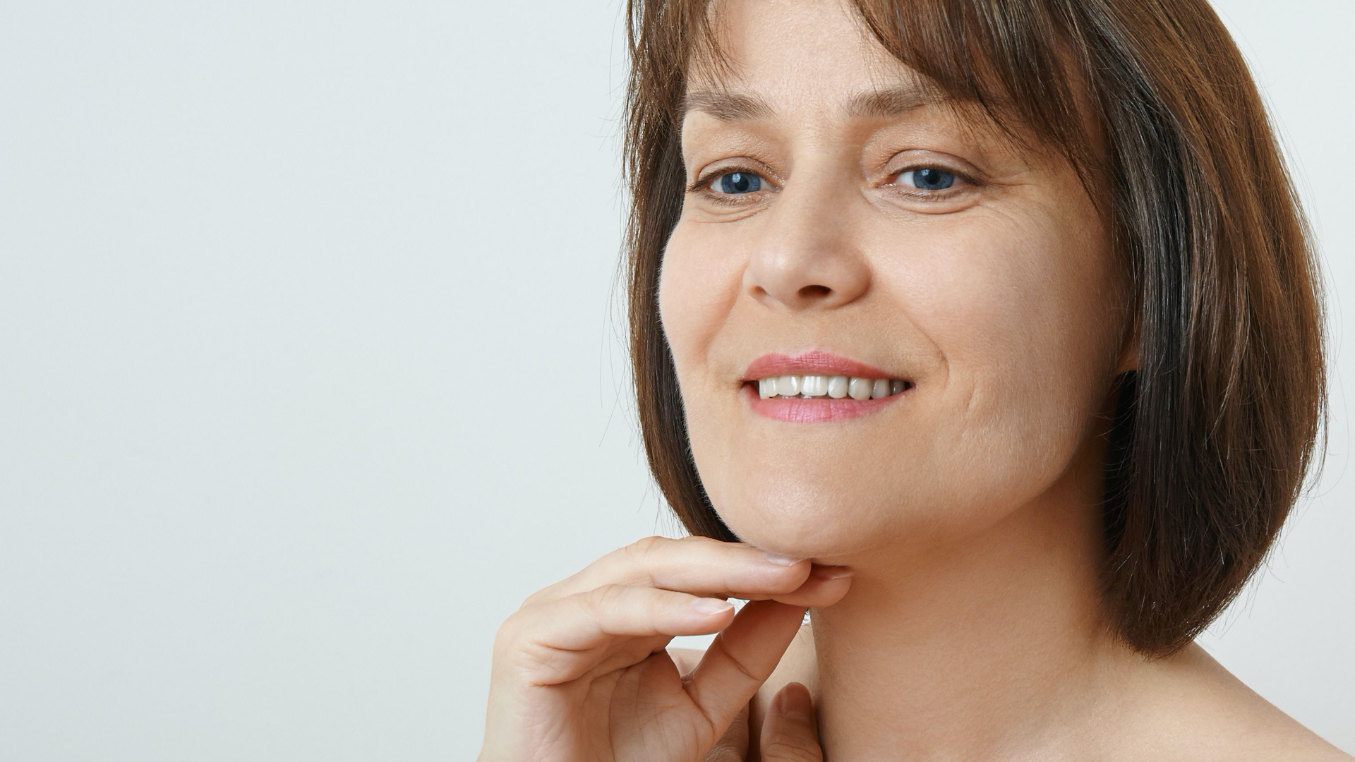 women touching her face and looking down