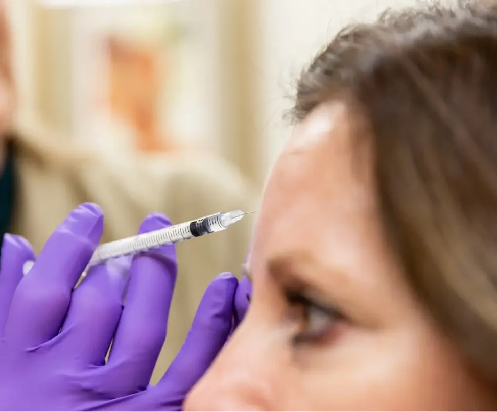 women getting an injection on her forehead