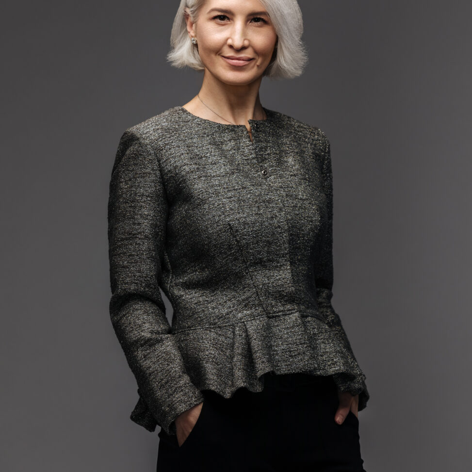 older woman wearing black posing