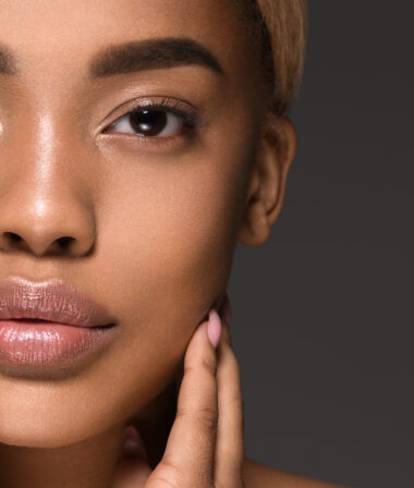 close up of a african america women touching her face
