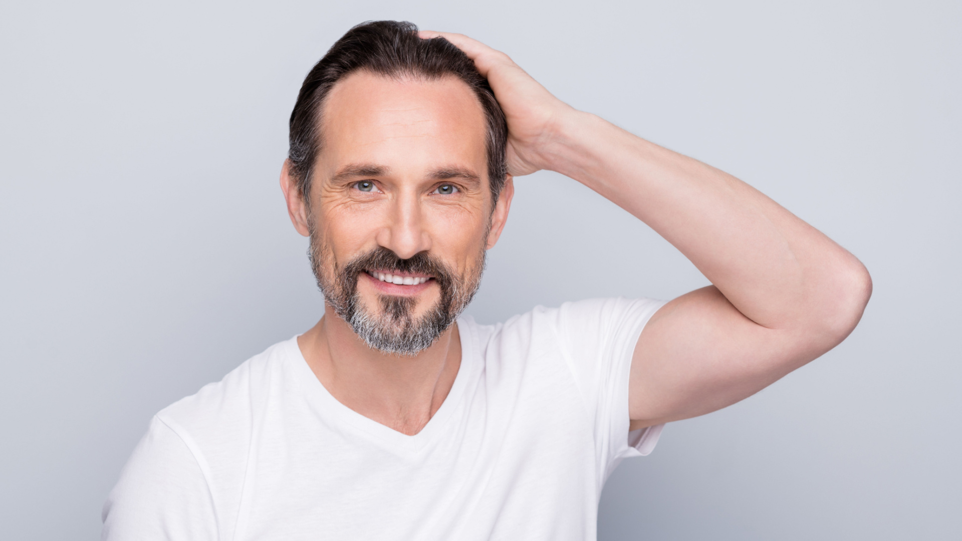 man with his hand on his head