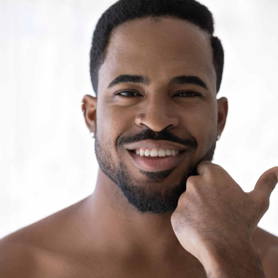 man looking in the mirror after laser treatments