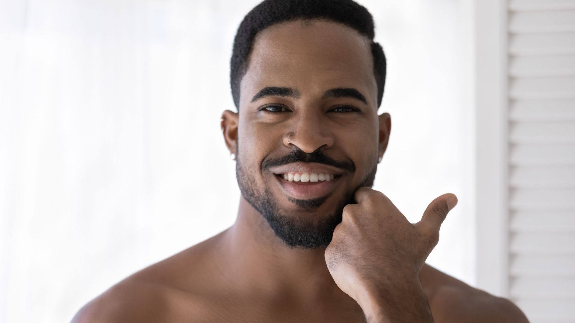 man looking in the mirror after laser treatments