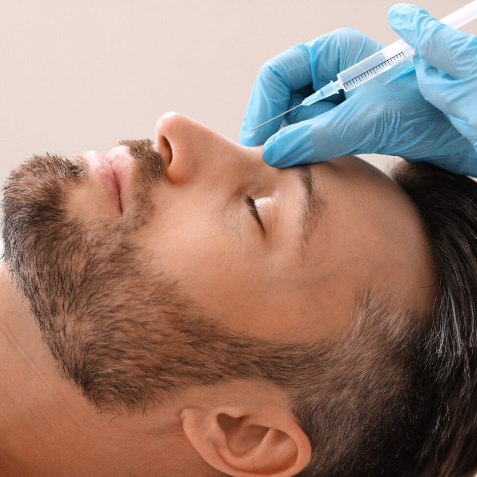man laying down getting work done on his face