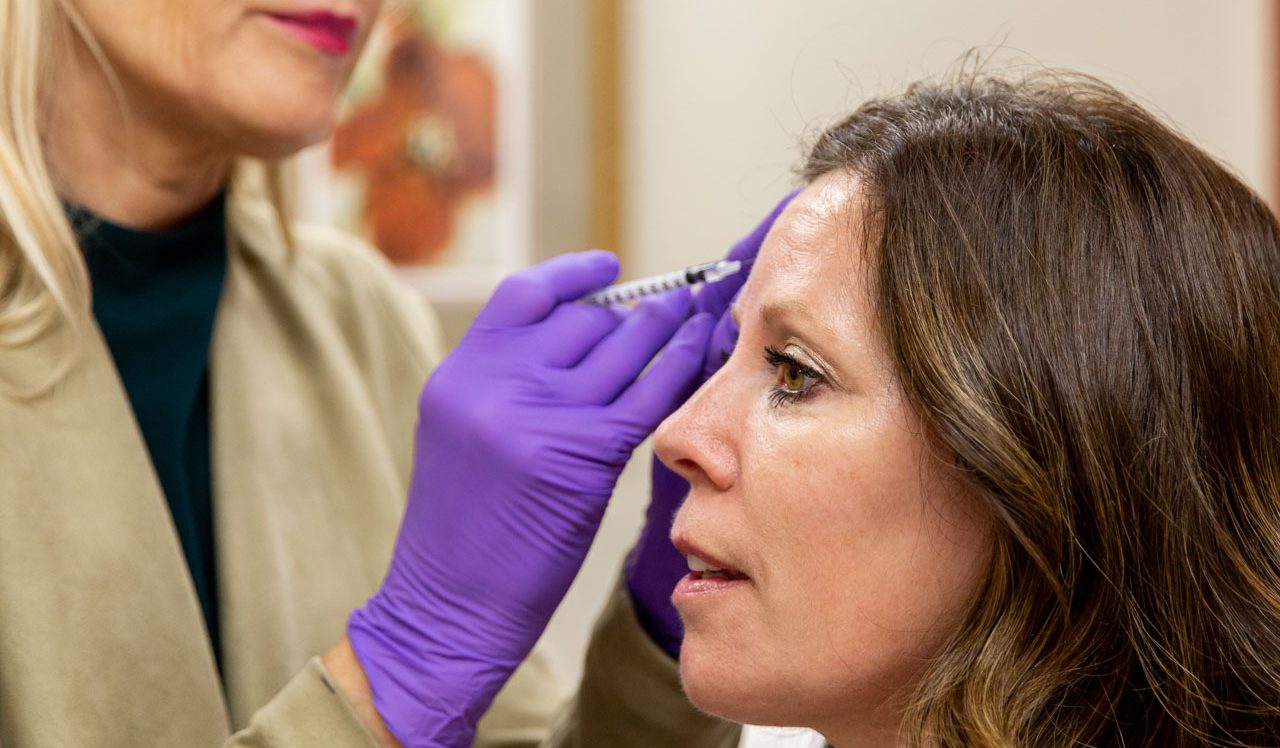 woman getting cosmetic injectable treatment in an office