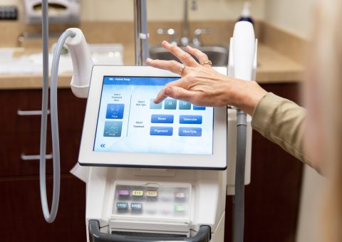 Technician selecting settings on a BroadBand Light (BBL) laser treatment device touchscreen at Skin Rejuvenation Clinic.