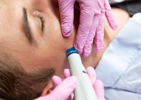 man getting HydraFacial by doctor