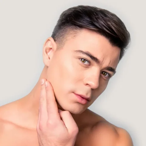 Man with defined facial features and balanced nasal profile against neutral background