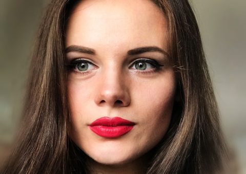 woman with long brown hair and bright red lipstick