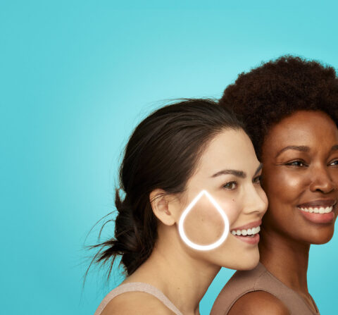Two women next to each other with a solid blue background