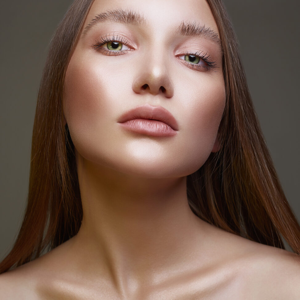 women wearing makeup looking at the camera after receiving a face lift.