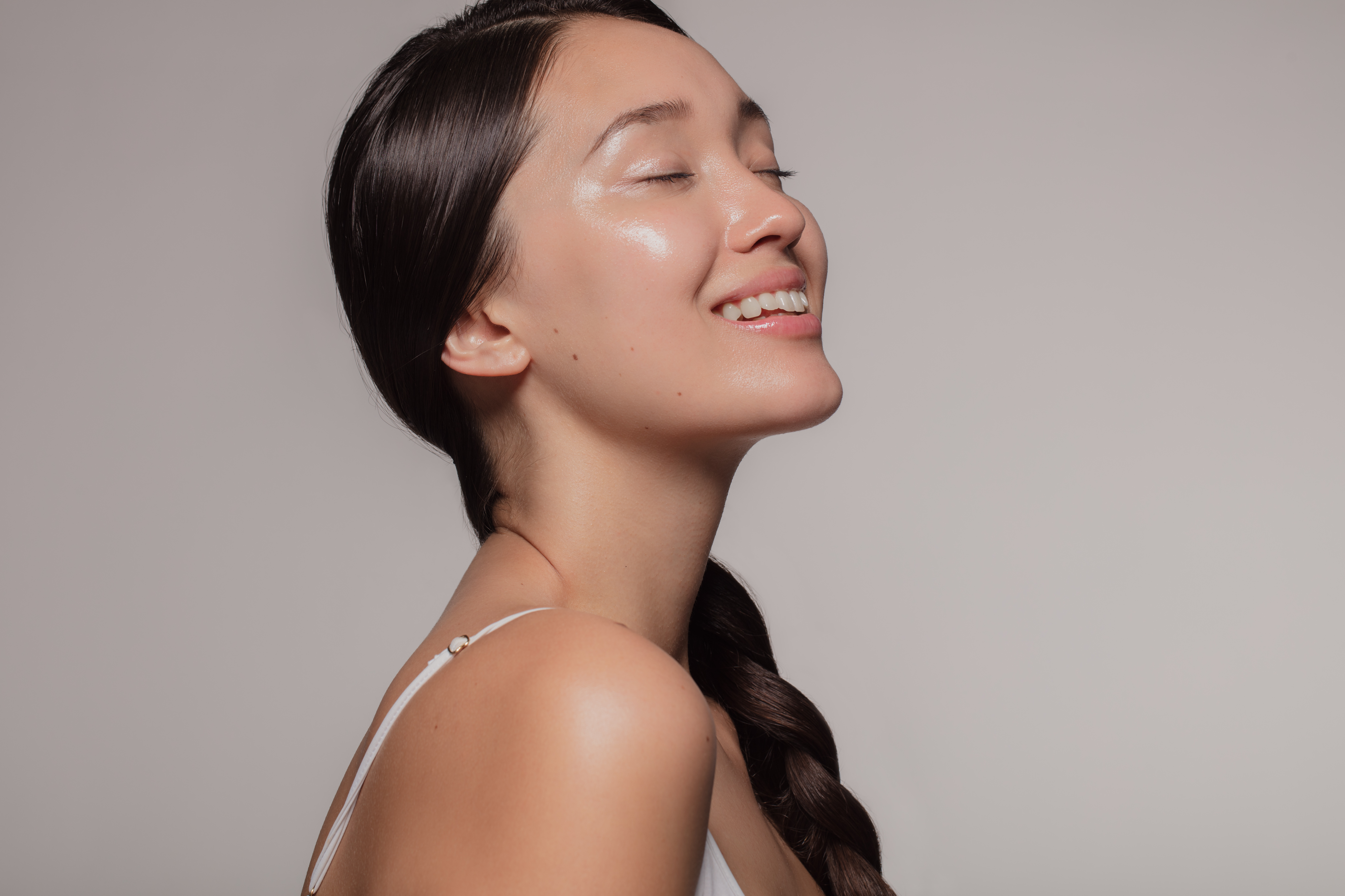 Asian Woman With Beautiful And Healthy Skin On Beige Background