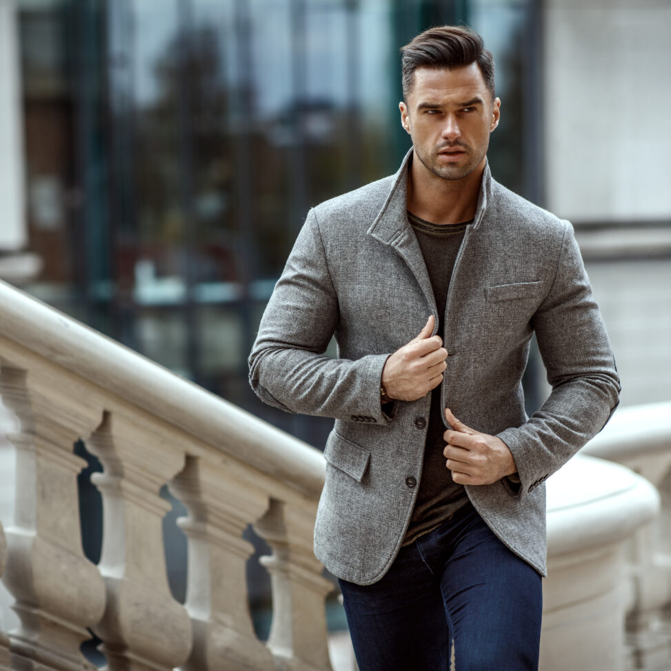man walking outside in a gray suit