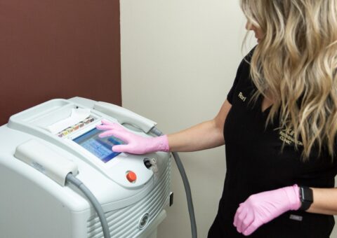 Woman using a laser hair removal machine