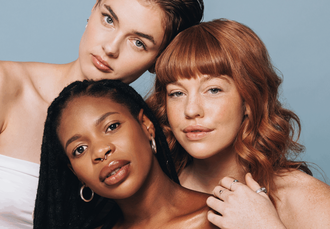 Three women with healthy, natural looking skin representing inclusive cosmetic clinic care, confidence, and personalized aesthetic treatments