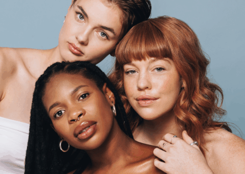 Three women with healthy, natural looking skin representing inclusive cosmetic clinic care, confidence, and personalized aesthetic treatments