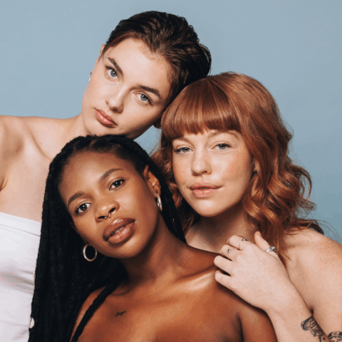 Three women with healthy, natural looking skin representing inclusive cosmetic clinic care, confidence, and personalized aesthetic treatments